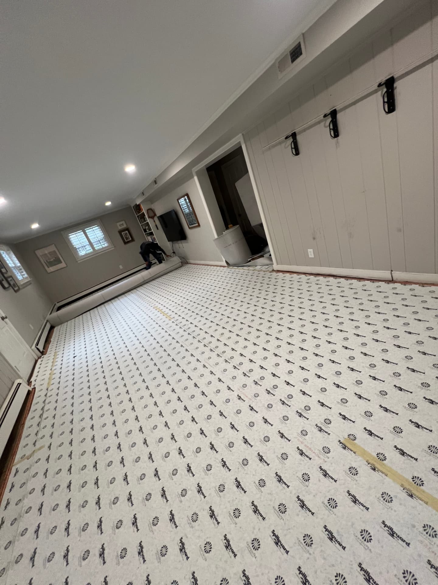 Living area with new carpet padding laid across the floor before installation